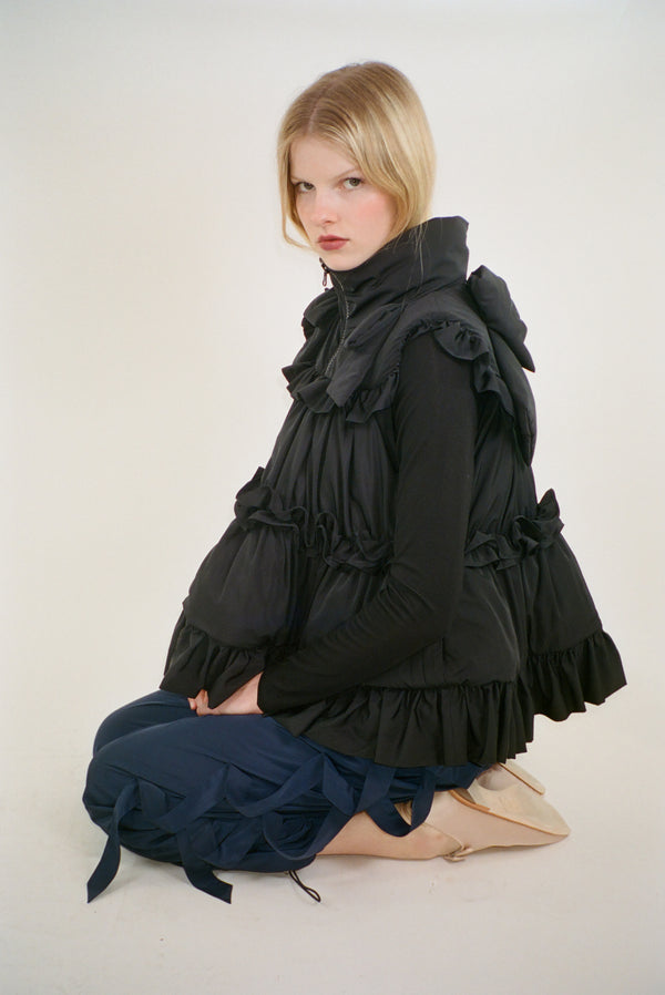 Puffer vest in black with ruffle details