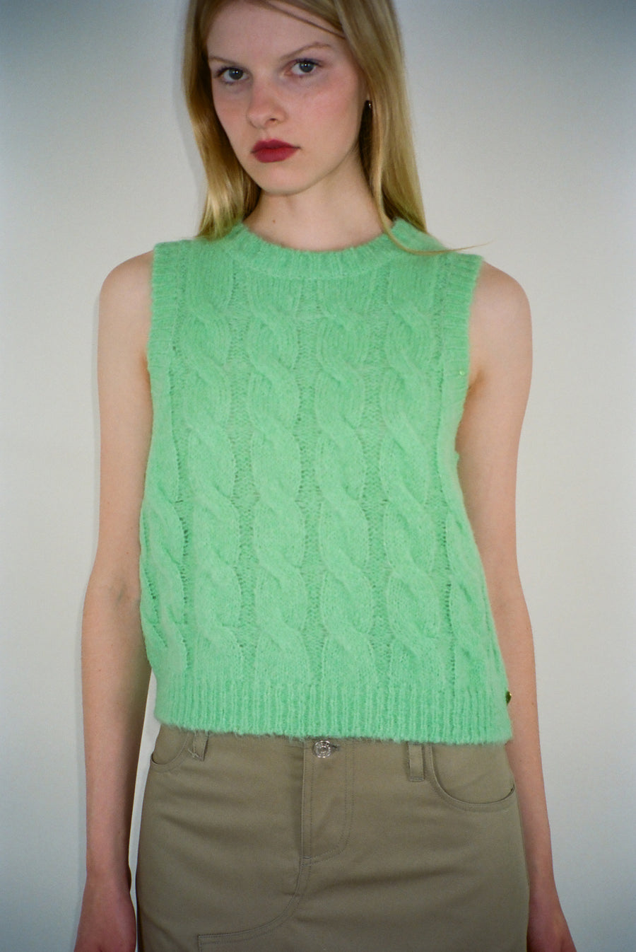 Cable knit sweater vest in lime green on model