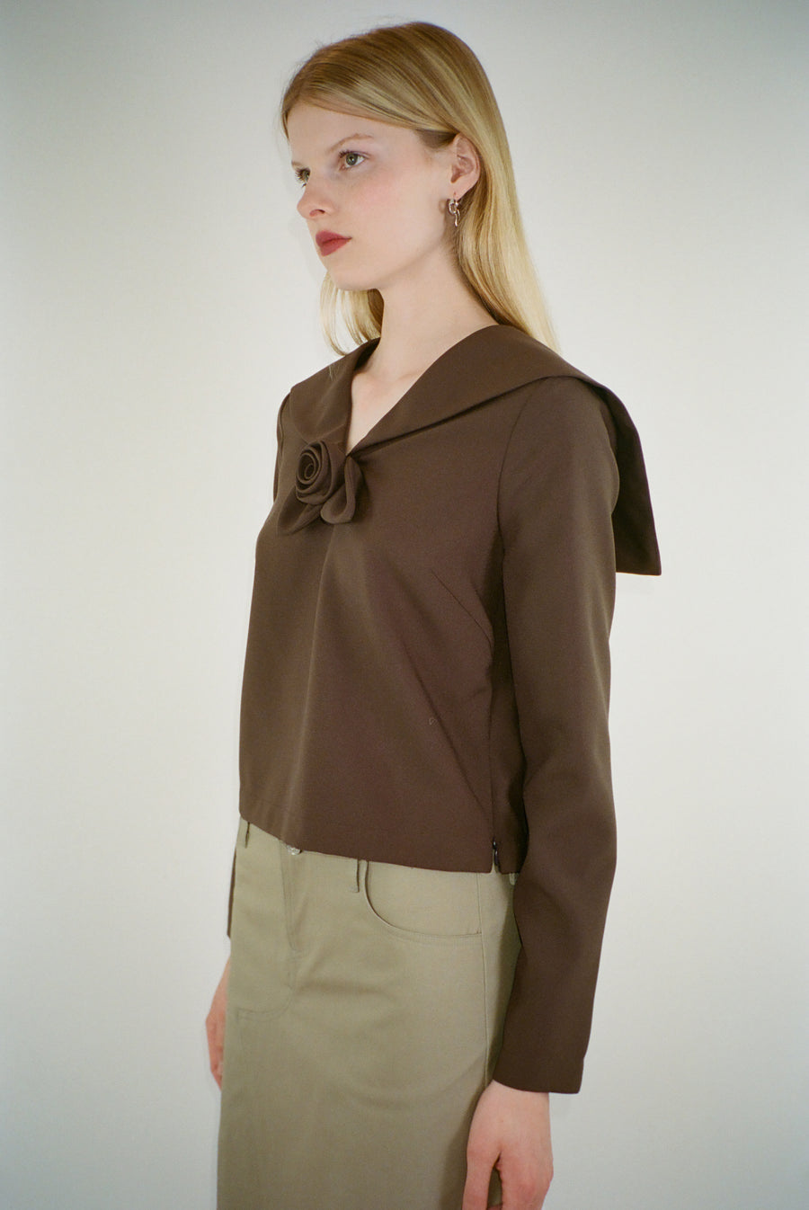 Long sleeve top in brown with sailor color and rose detail at front on model