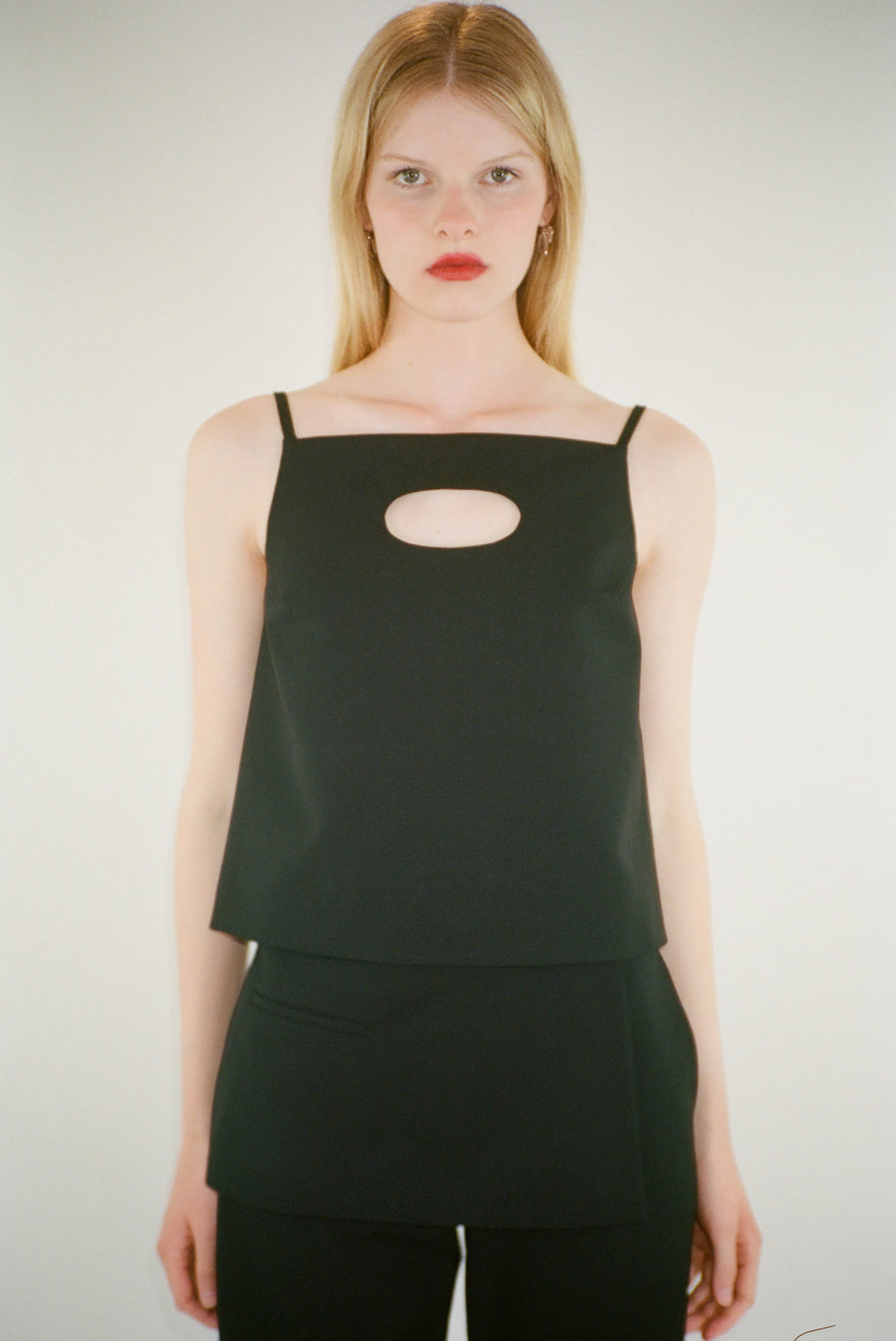 Boxy top in black suiting fabric with cut out detail at front on model