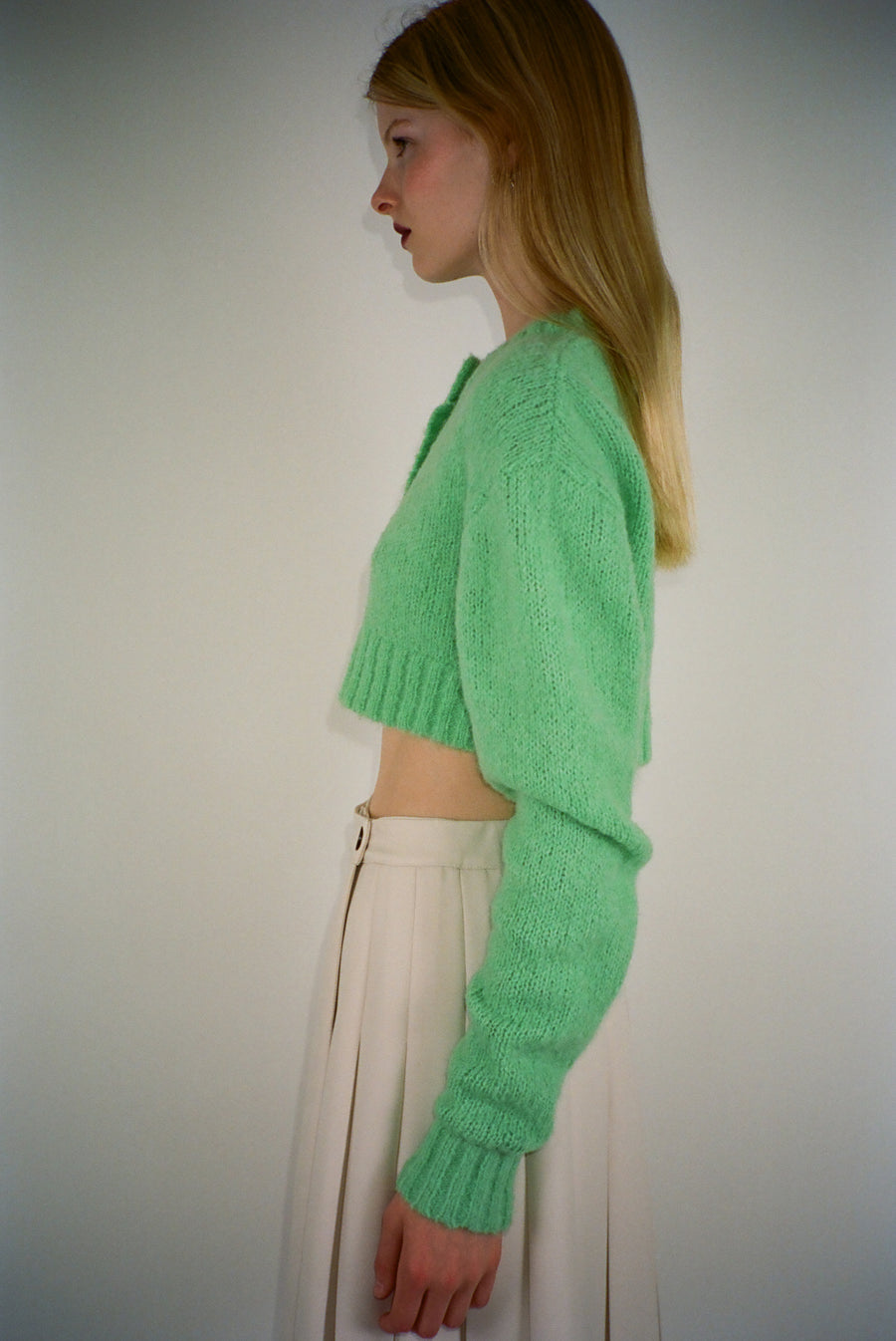 Cropped knit cardigan in lime green with buttons on model