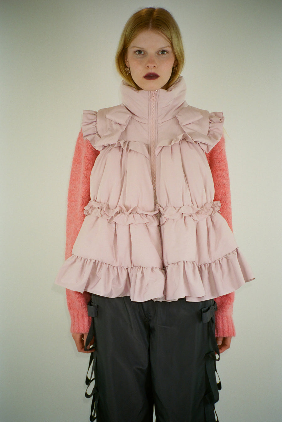 Puffer vest in pink with ruffle details on model