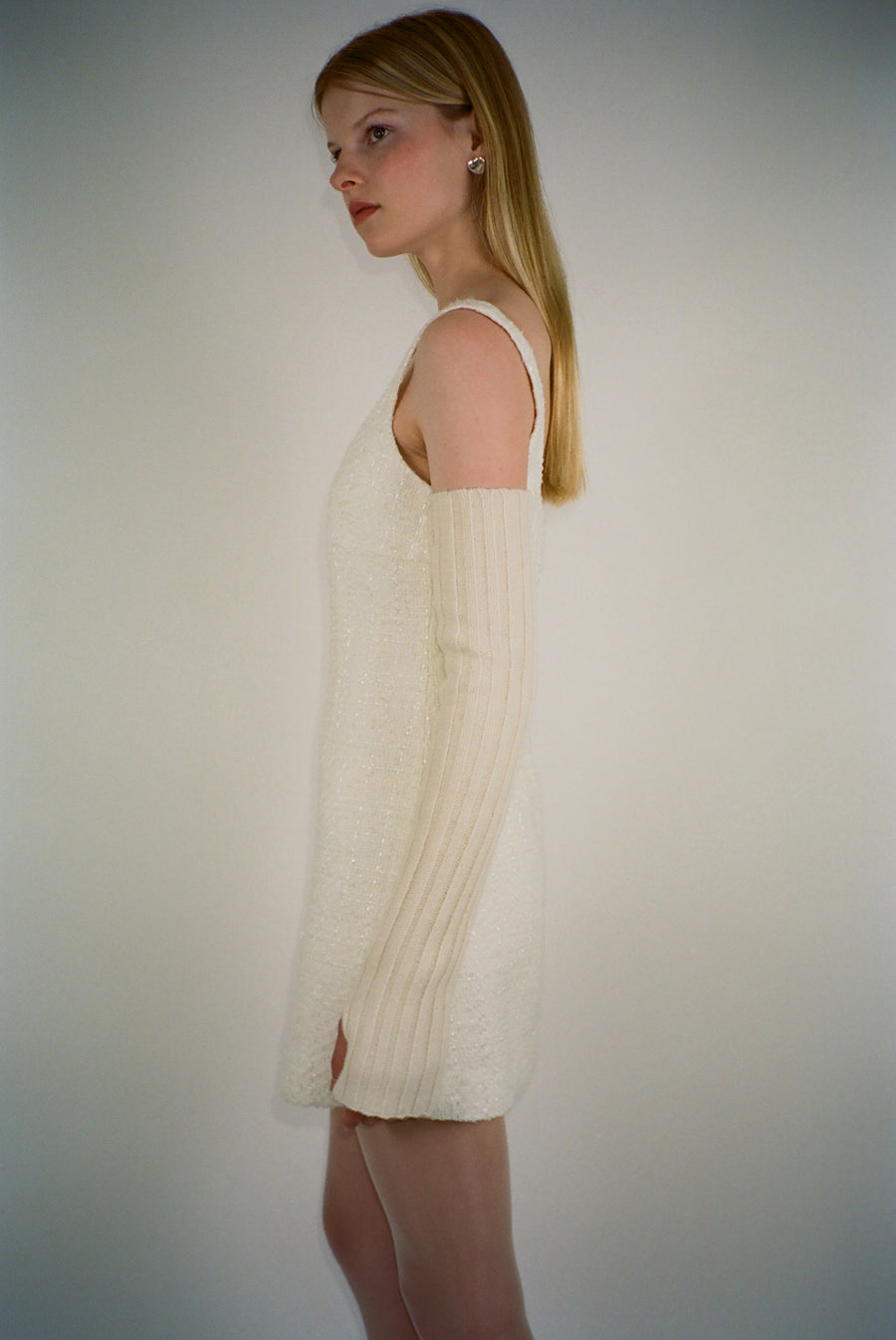 Sleeveless mini dress in off white tweed on model