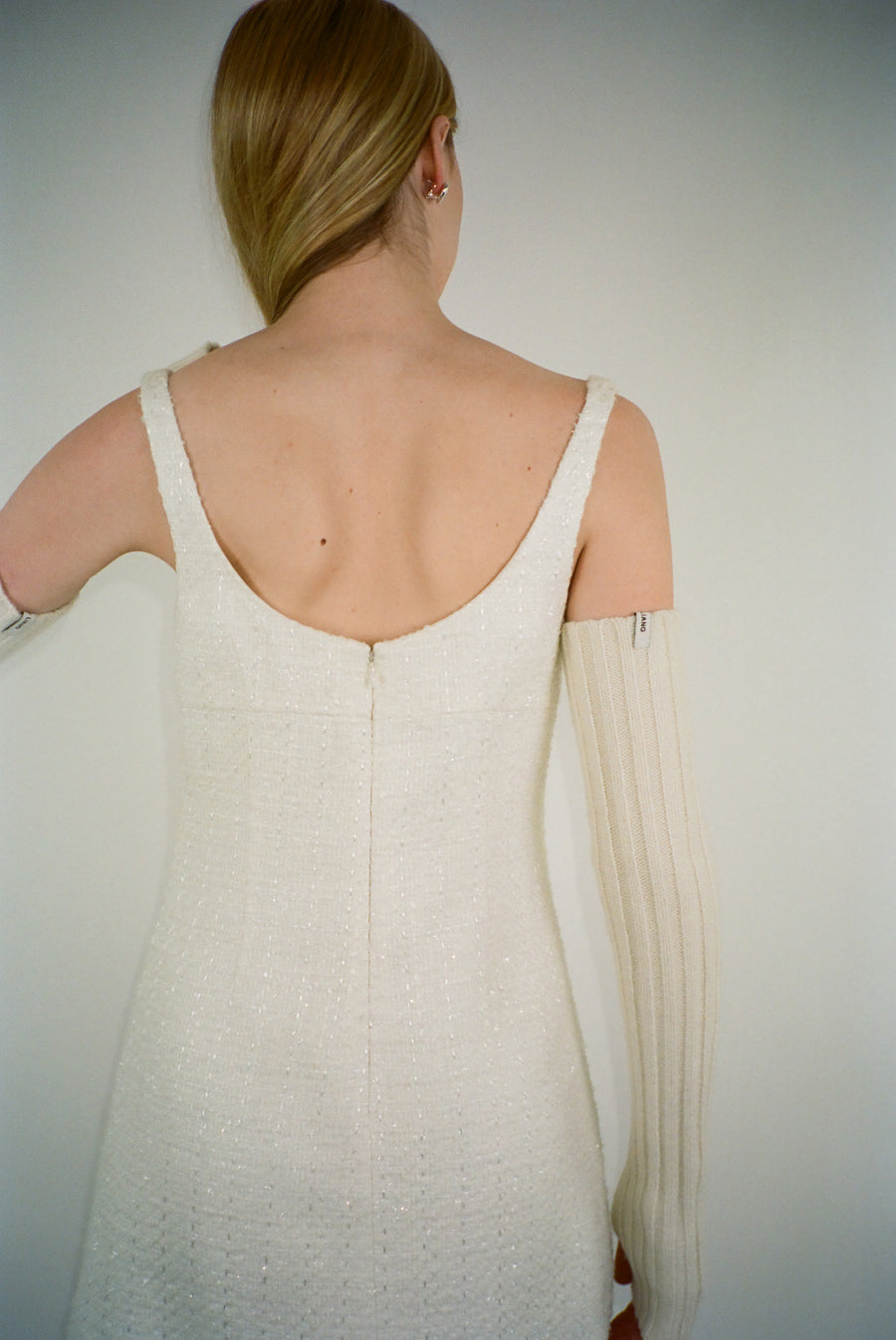 Knit arm warmers in cream with thumbhole on model