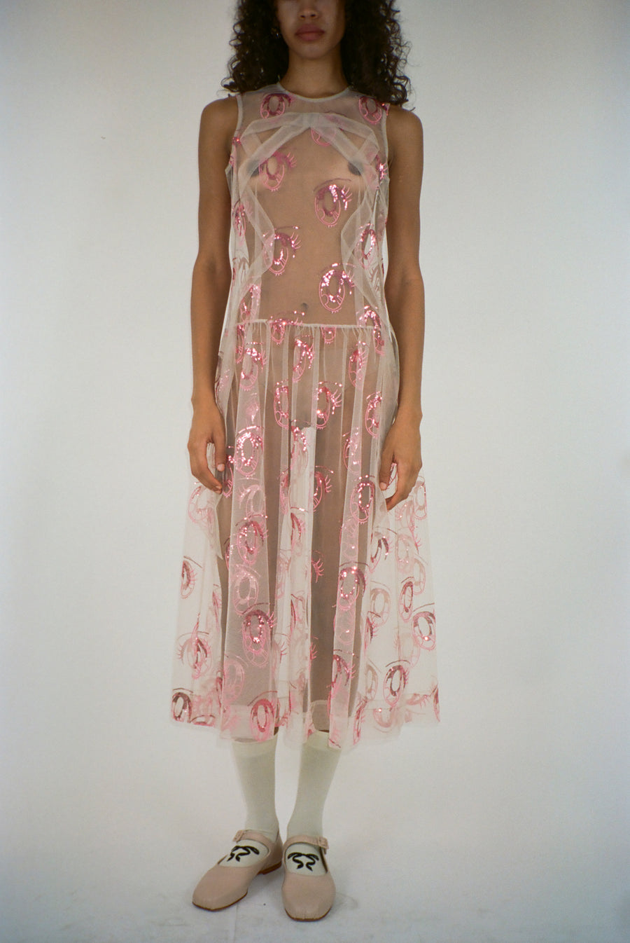 Midi length dress in pink tulle with anime eye print on model