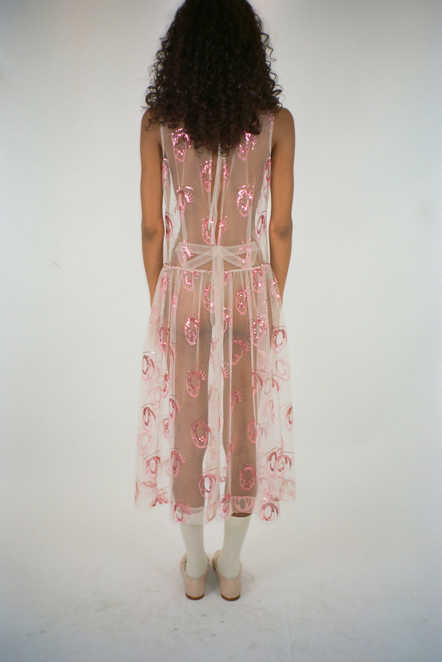 Midi length dress in pink tulle with anime eye print on model
