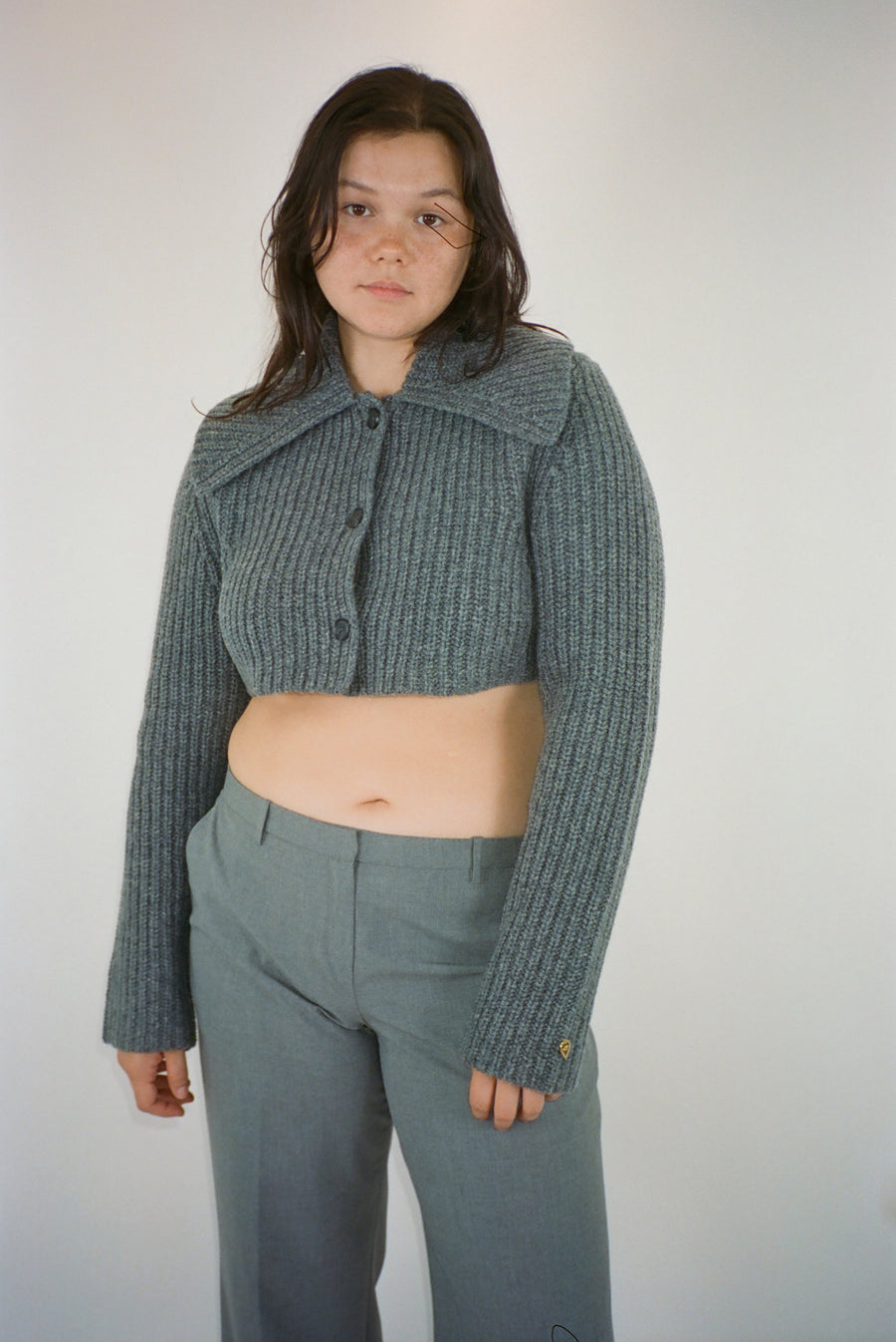 Cropped cardigan sweater in grey with button closure on model