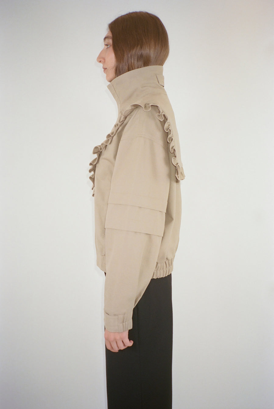 Oversized jacket in taupe with ruffle detail on model