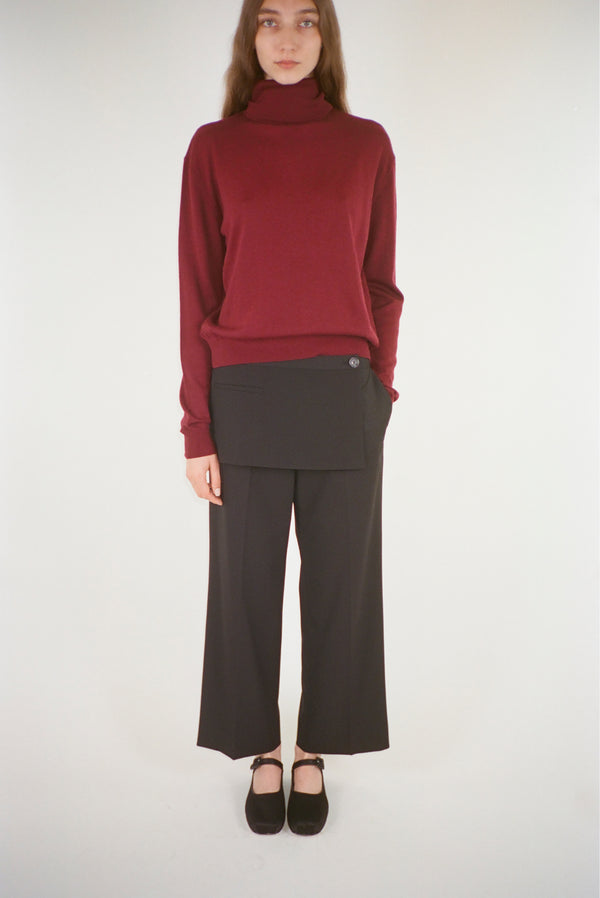 Mid rise pants with apron detail in a black suiting fabric