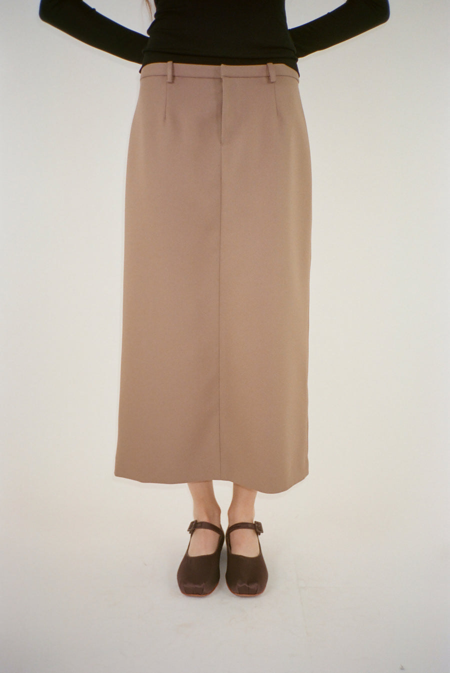 Midi length skirt in taupe suiting fabric on model