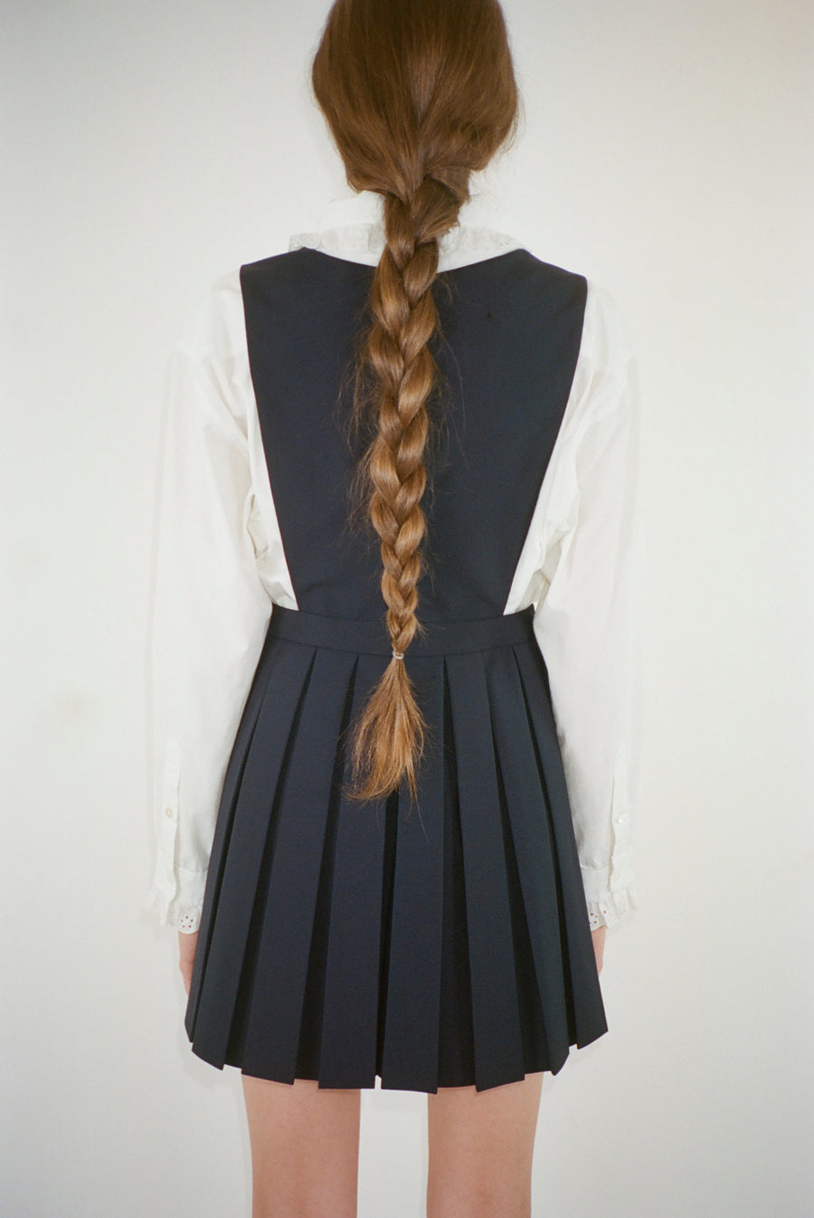Wool pleated mini dress in navy on model