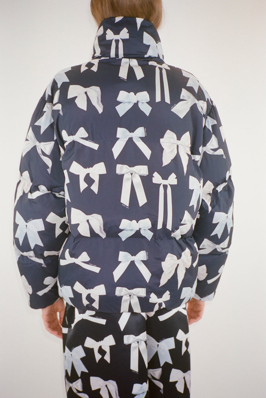 Puffer jacket in bow display print on model