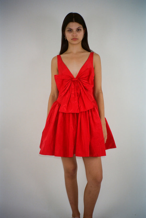 Mini dress in red taffeta with bow at front and cape in back