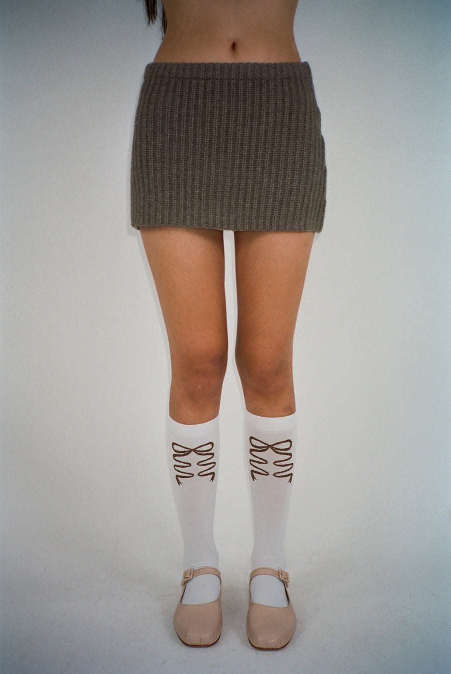 White knee high socks with brown bows on model