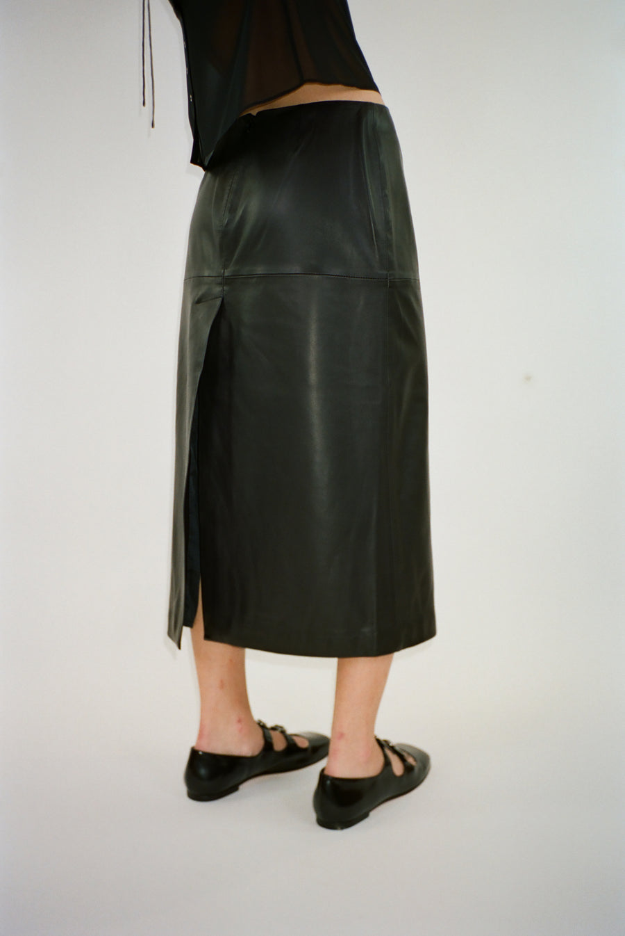 Midi length skirt in black nappa leather on model