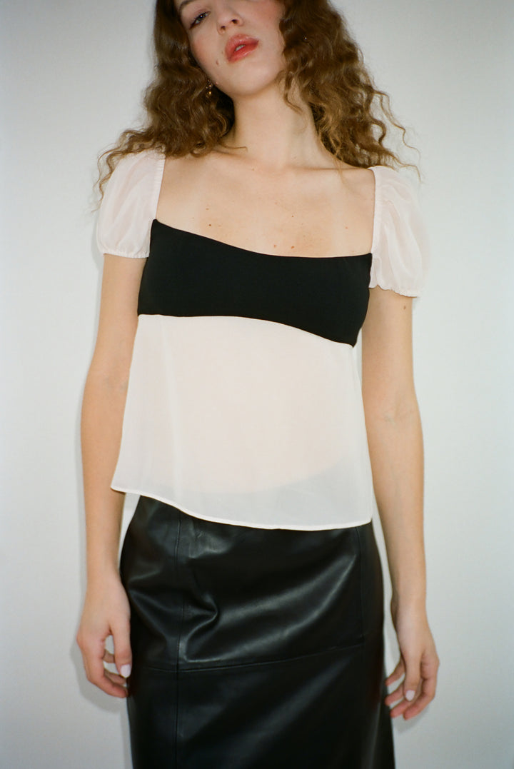 Short sleeved top in black and off white with semi sheer bodice on model