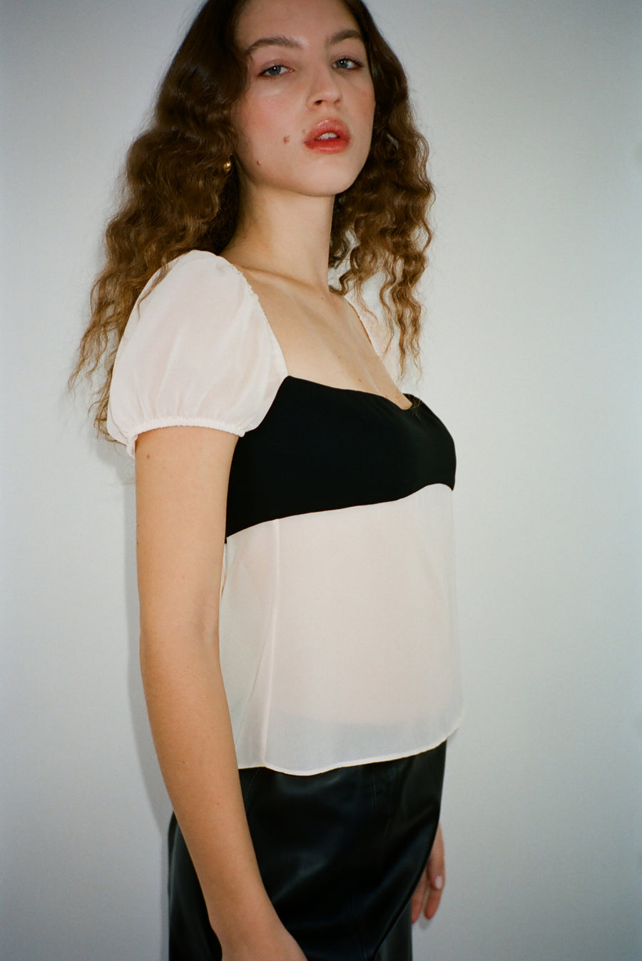 Short sleeved top in black and off white with semi sheer bodice on model