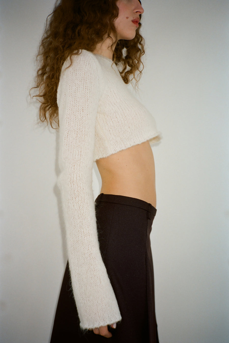 Cropped knit sweater in off white on model
