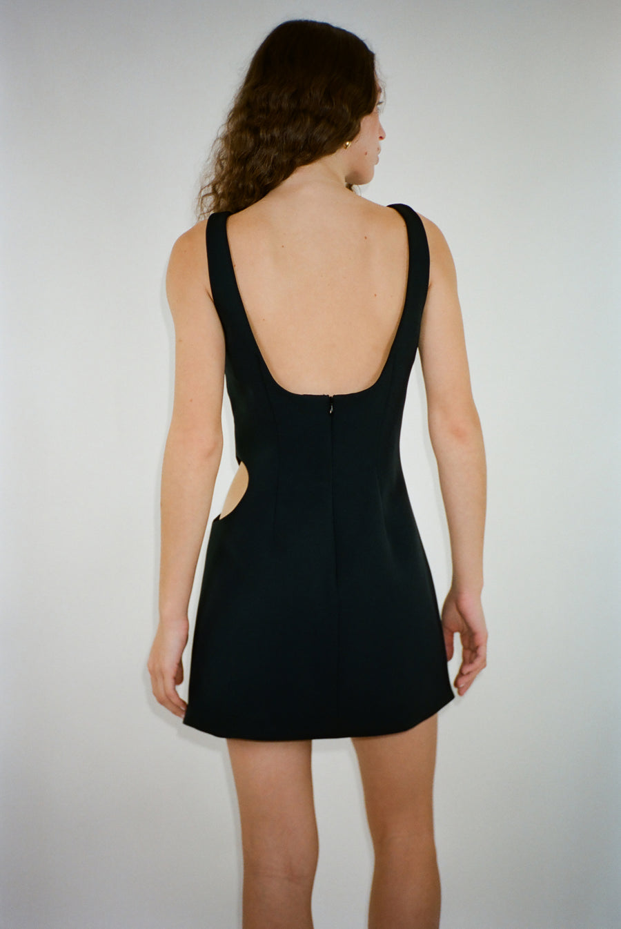 Mini dress in black with cut out on side on model