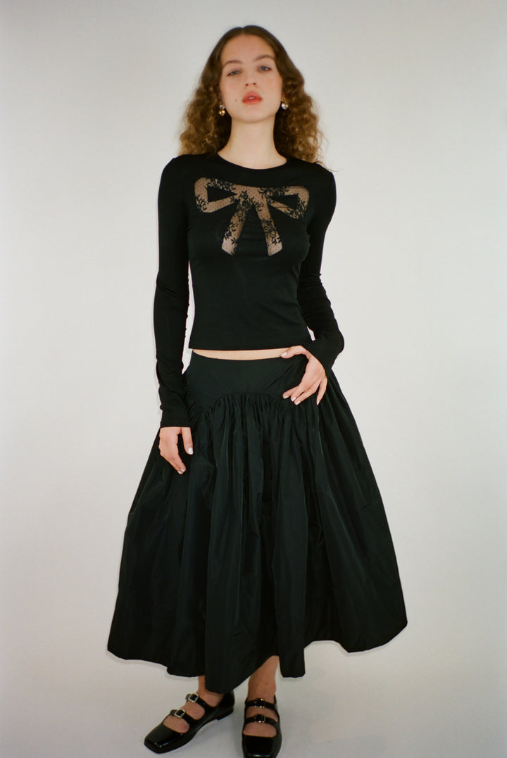 Long sleeve top in black with lace cut out bow detail on model