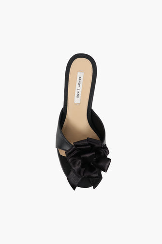product image of a black heel shoe with bow on a white background