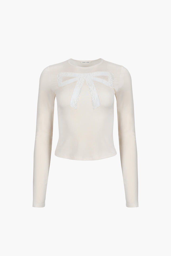 Long sleeve top in off white with lace cut out bow detail