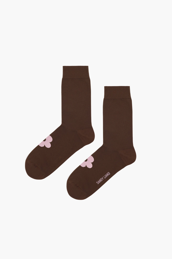 Brown crew length sock with pink flower on foot