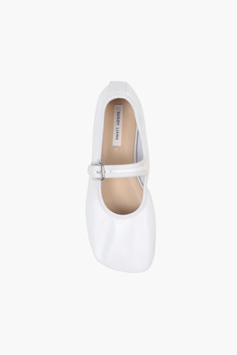 A top view of a single white Mary Jane shoe with a buckle strap and a low heel, on a white background.