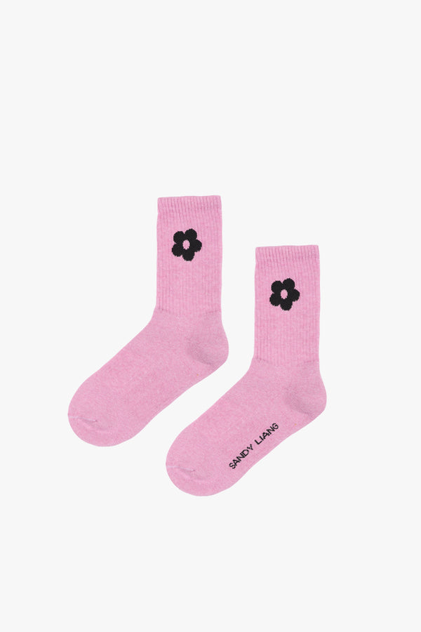 Tums pink crew length sock with black flower on either side