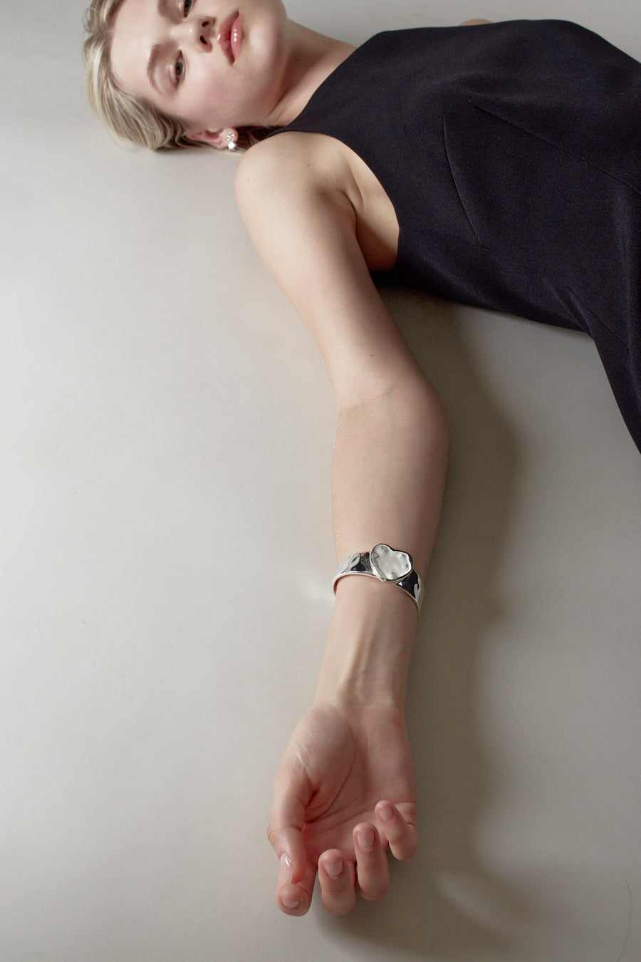 Sterling silver plated heart arm cuff on model