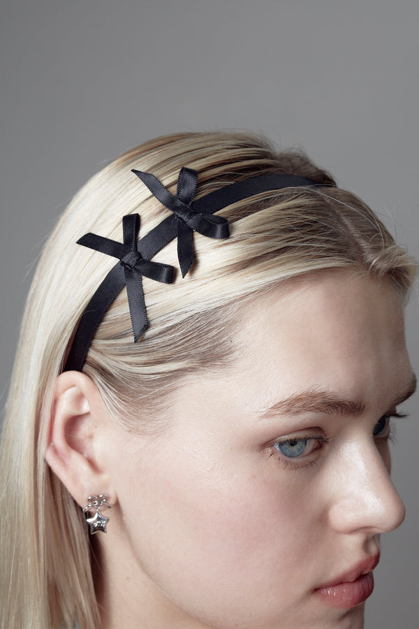 Black headband with two small bows on either side