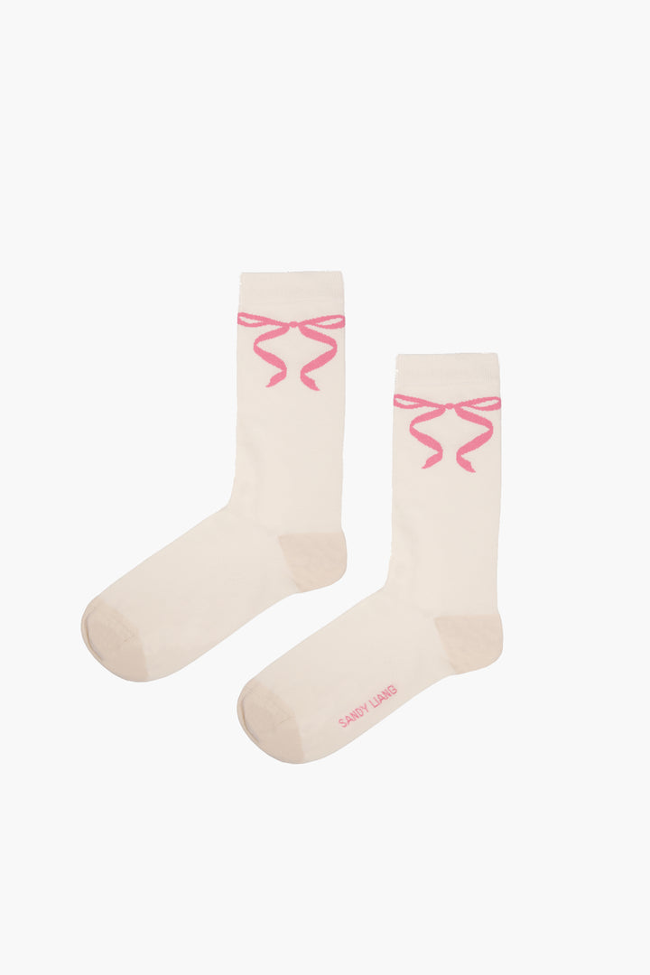Butter yellow crew length socks with pink bows on either side