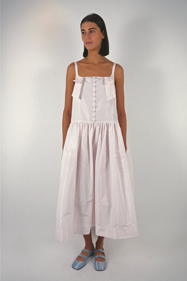 Midi length dress in blush pink taffeta with buttons and cape detail at back