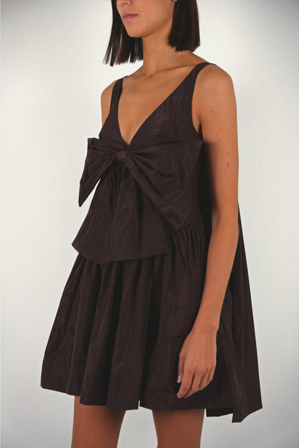 Mini dress in coffee brown taffeta with bow at front and cape in back