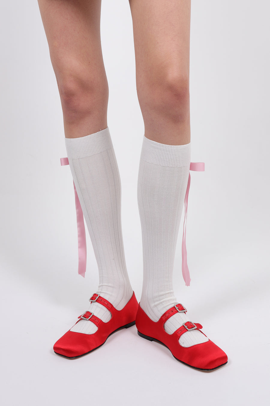 Cotton blend knee high socks in off white with pink long satin bows at side on model