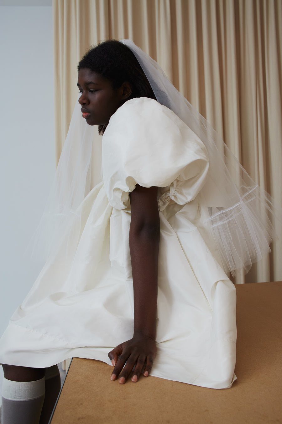 White veil with ruffles at hem on model