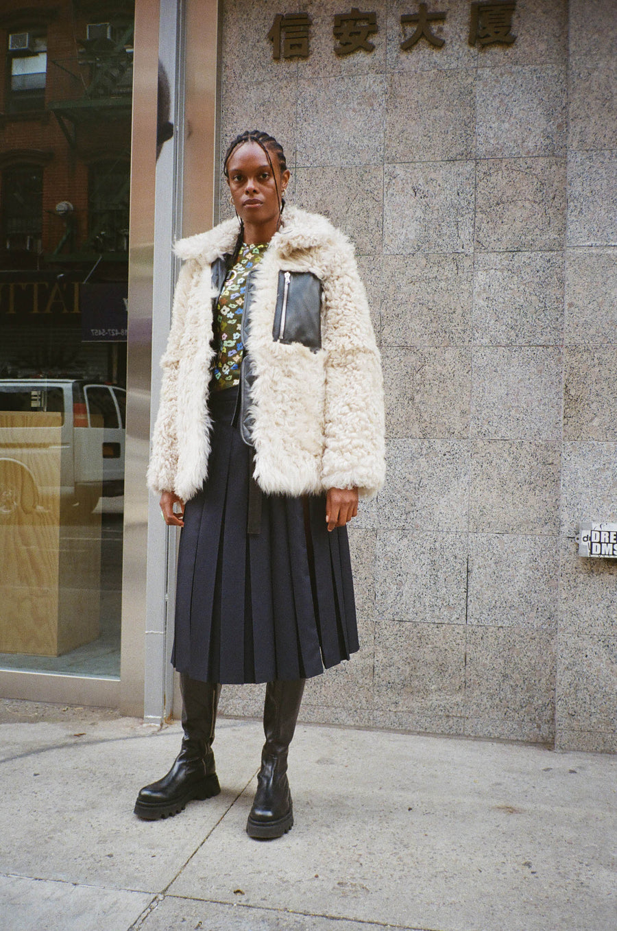 Reversible black nappa leather and cream shearling coat on model