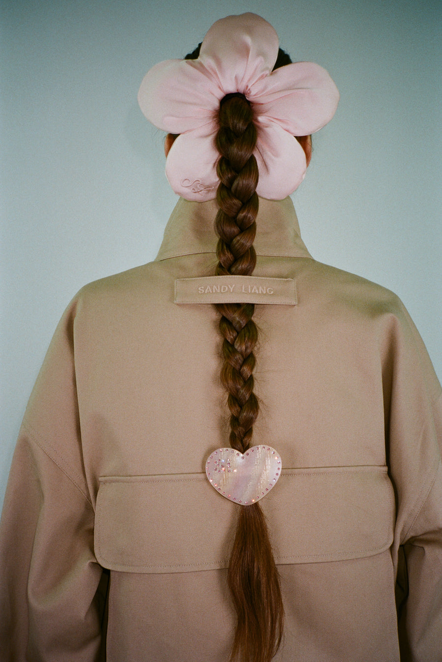 Pink flower shaped hair scrunchie on model